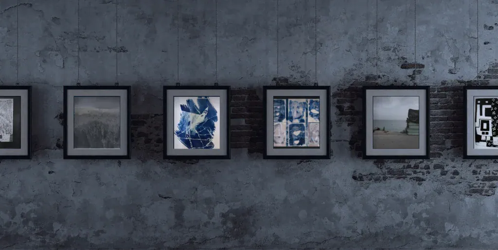 Framed artworks by Palestinian artists hanging on a dark gallery wall